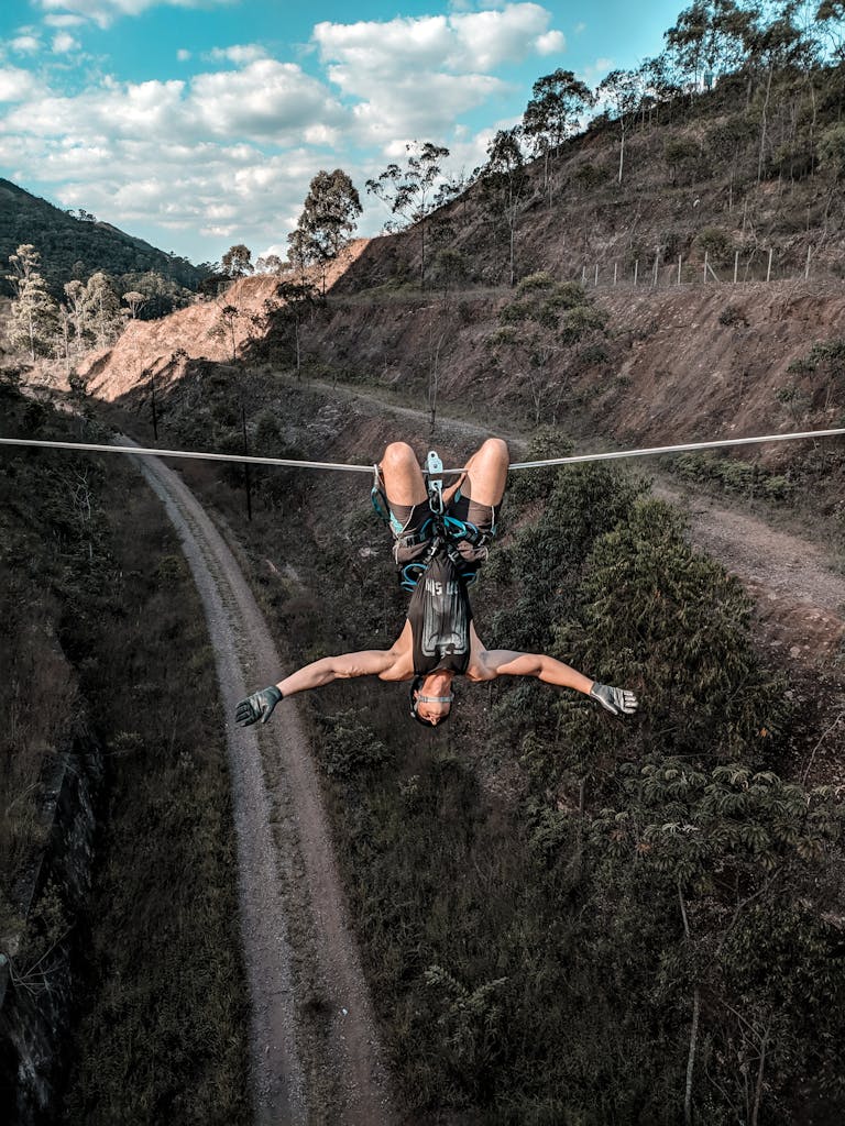 Man In Black Tank Top Hanging On A Rope